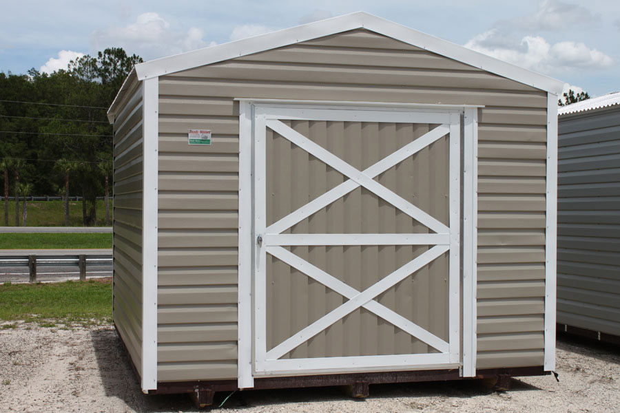 Tan aluminum shed with white trim