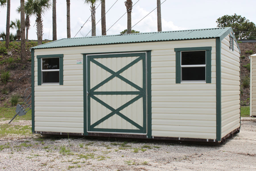 Beige aluminum shed with green trim