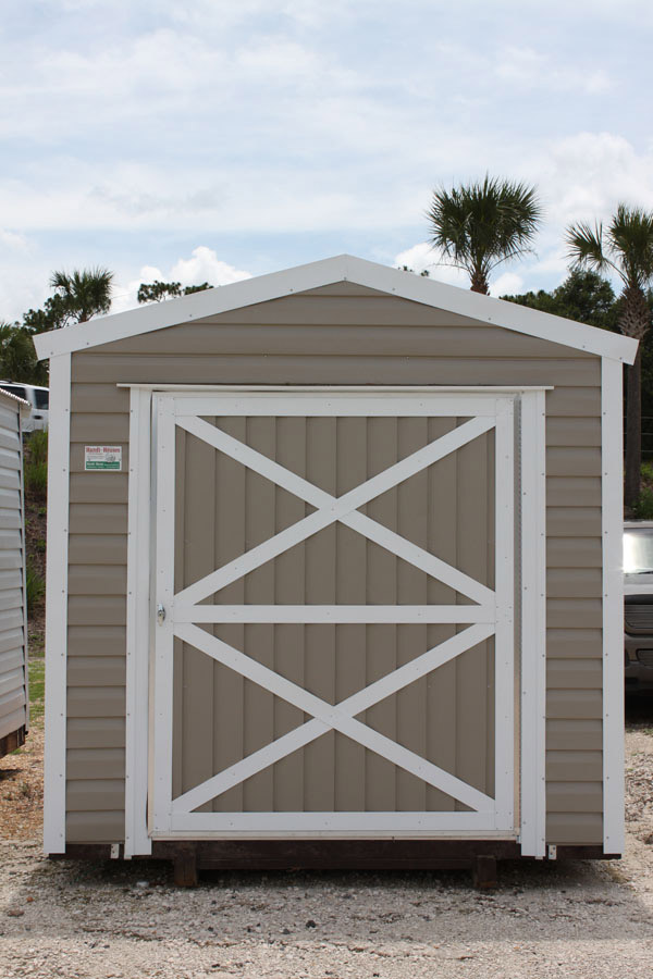 Front view of a tan aluminum storage shed